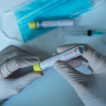 Hands,Of,A,Doctor,Showing,A,Positive,Coronavirus,Test,,In